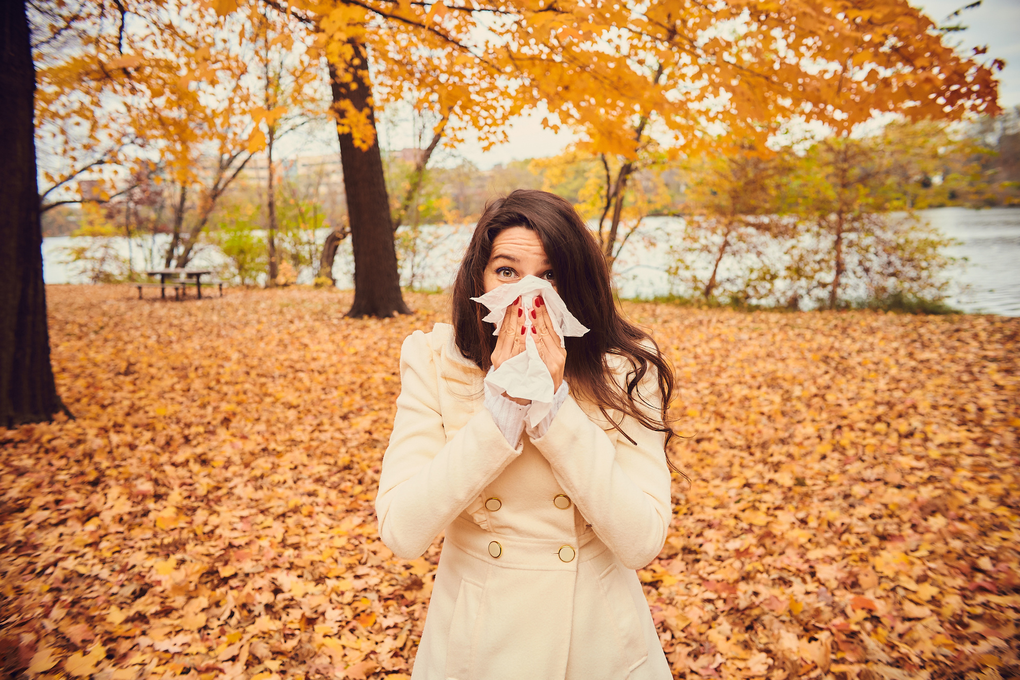 young woman blowing nose